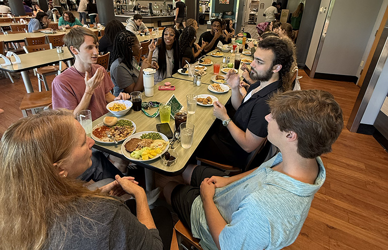 ASL-1 Lana Cromeenes and students conversing in ASL over lunch in the USC Upstate dining room
