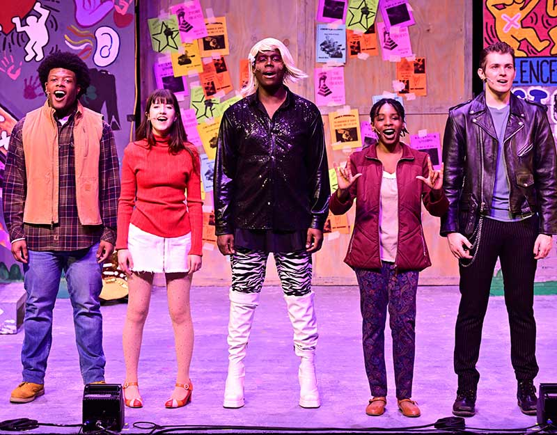 web-asl2 Cayden Nixon signs while singing her part with other members of the cast of "Rent"