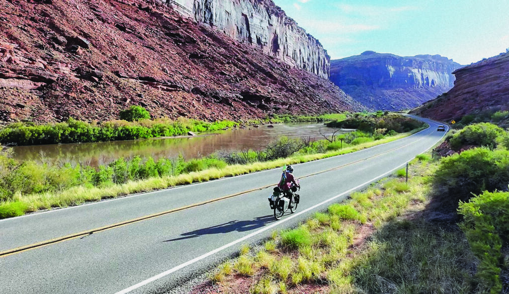 Mufaddal Fidahussein biking down the highway