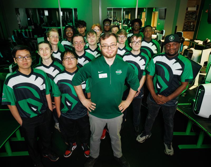 Nick Matawa stands with his esports team in USC Upstate's esports arena.