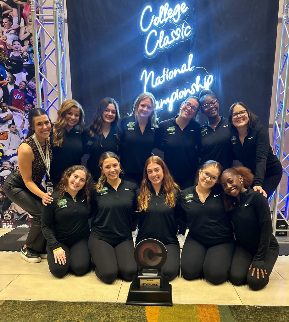 Team_victory The dance team poses with their fourth place trophy at the College Classic in April