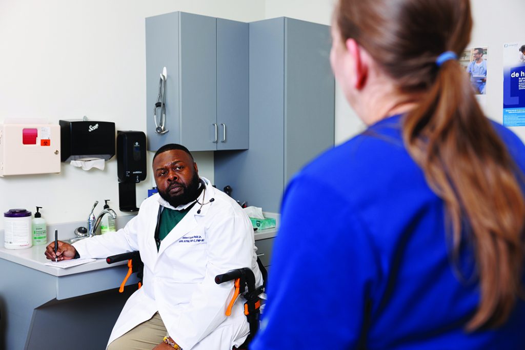 312A5774.CR3 Robert Reid talks to a nurse at the clinic
